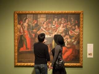 Man and woman looking at painting