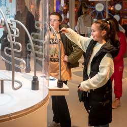 Girl interacting with robot exhibit at Eureka! Science + Discovery