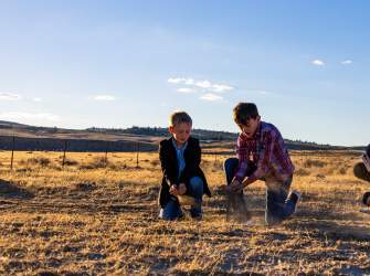 Historic Trails West - kids touching the dirt on the Oregon Trail