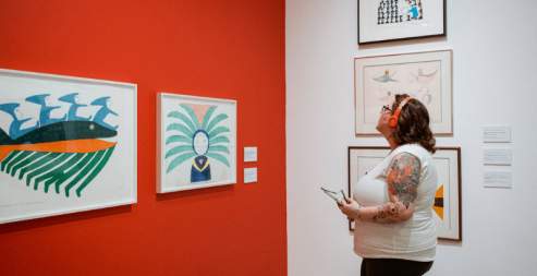 A person viewing different piece of art at the Nanaimo Art Gallery.