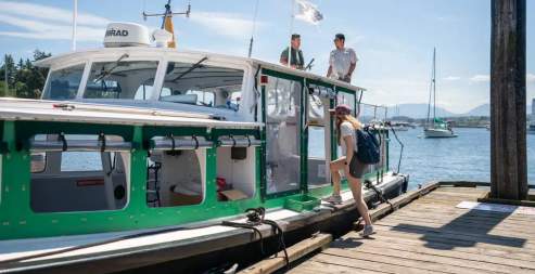 A person boarding a small ferry.