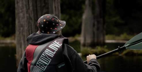 A person kayaking in a drowned forest.