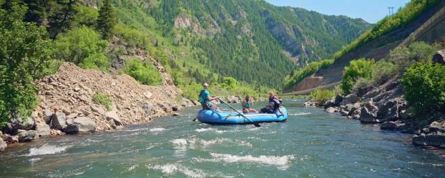 inflatable raft floating down scenic Provo River