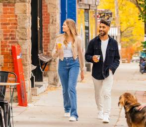 Couple walking down sidewalk in downtown Ann Arbor