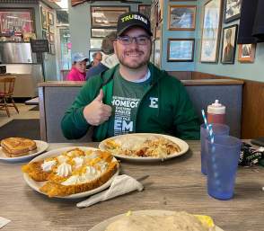 Man eating a big breakfast at The Bomber in Ypsilanti