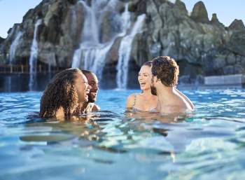 Two couples laughing in the water at Universal's Volcano Bay