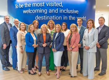 2026 Executive Leadership Team or Executive Management Team standing in the lobby of the Westwood suite