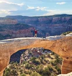 Man Standing on top of Rattlesnake Arches