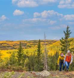 Two people hiking in the fall on the Grand Mesa