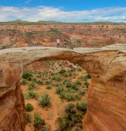 Hiking across an arch in Rattlesnake Canyon