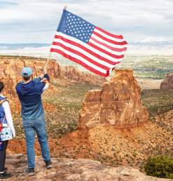 People Posing with American Flag on Colorado National Monument