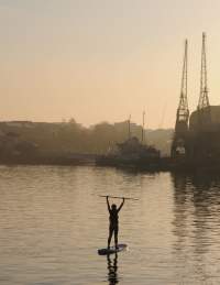 someone SUPing at Sunset