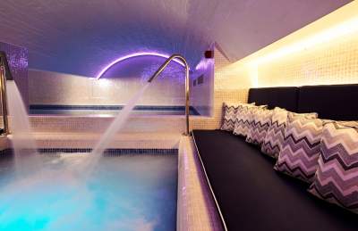 Underground swimming pool with water jets and seating at HarSpa at Harbour House Hotel