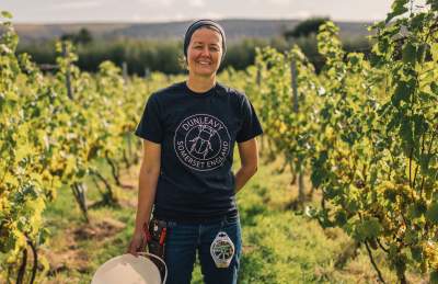 A woman standing in a vineyard in North Somerset near Bristol - credit GOOD Stories in Food