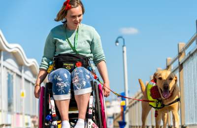 A wheelchair user and their dog on the Grand Pier at Weston-super-Mare near Bristol - credit The Grand Pier