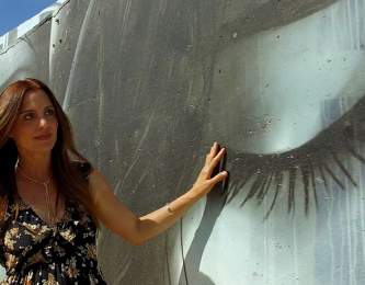 Woman admiring a black and white mural.