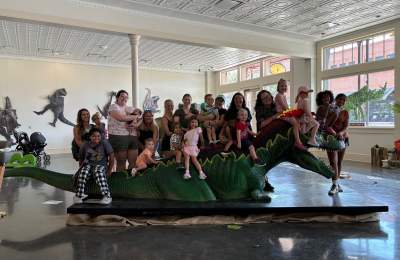 Group takes picture at Grapevine CVB Dino exhibit