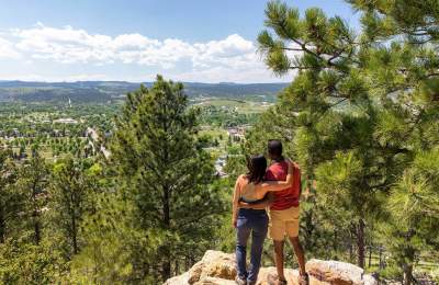 Hikers enjoying the scenic overlook of rapid city from the trails of skyline wilderness area