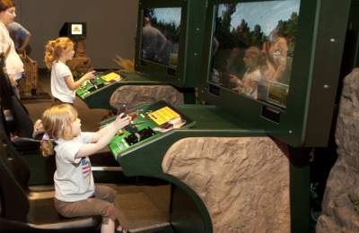 Video games being played in Be The Dinosaur Exhibit