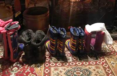 Line of wellie boots in front of fire at Waterloo Arms pub in Lyndhurst in the New Forest - Pub walks insp