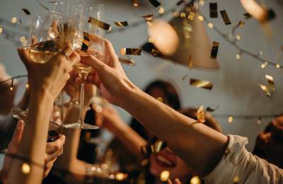 People cheersing champagne glasses at New Years celebration