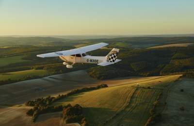 A plane flying over Sussex countryside