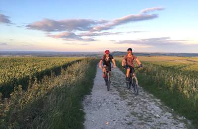 Two people cycling in countryside