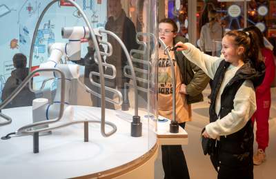 Girl interacting with robot exhibit at Eureka! Science + Discovery