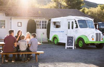 Family eating ice cream outside Harmony Valley Creamery scoop truck
