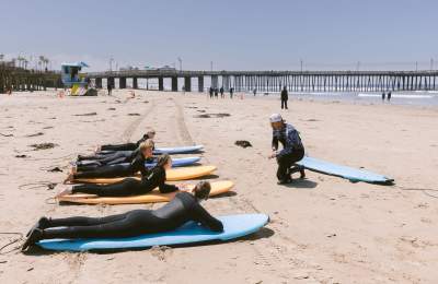 group getting ready for a surf lesson with Pismo Surf Academy