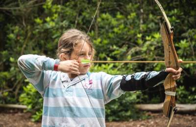 Girl doing archery at New Forest Activities - Activities Hero