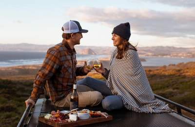 Couple enjoying wine and picnic outdoors
