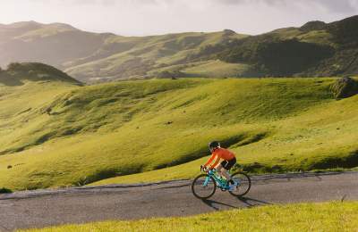 man cycling on backroad in SLO CAL
