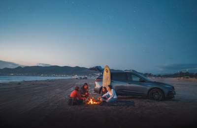 People around a bonfire on the beach