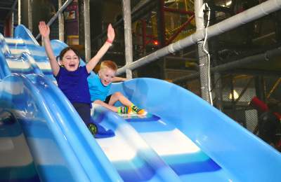 Kids On A Slide At Uptown Jungle Fun Park In Chandler, AZ