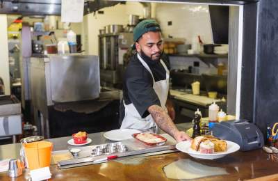 Chef serving up dishes at the window