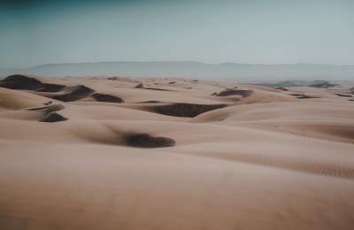Landscape of dunes for miles with hills in background