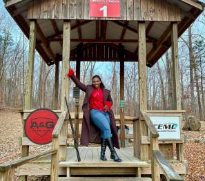 lady standing in a clay shooting station