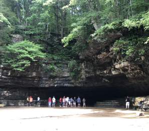 people standing for a tour at the cave opening at Dunbar Cave