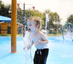 boy playing in a plash pad