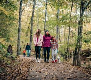 Family on trails in the fall time at Rotary Park