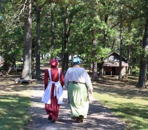 two women walk in period clothing