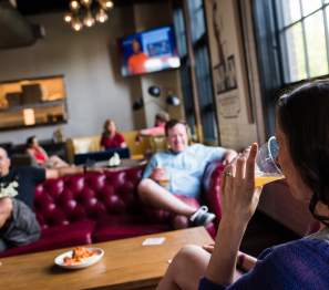 three people  hanging out in a pub