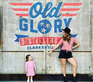 mom and daughter by a mural