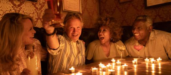 Four people sitting at a table enjoying a meal