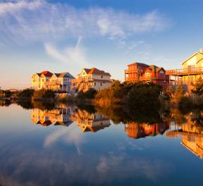 Homes sit on the water's edge, granting their occupants the best Outer Banks sunset views.