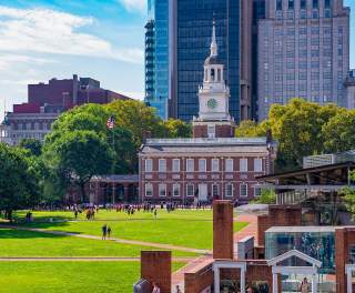A large clock tower known as Independence Hall in Philadelphia on a sunny day
