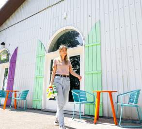 Woman walking with 6-pack of cider