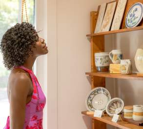 Woman walking through pottery gallery