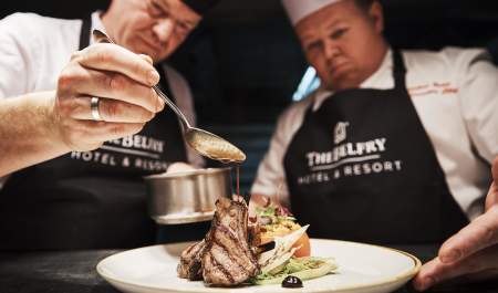 Chefs creating plate of food.